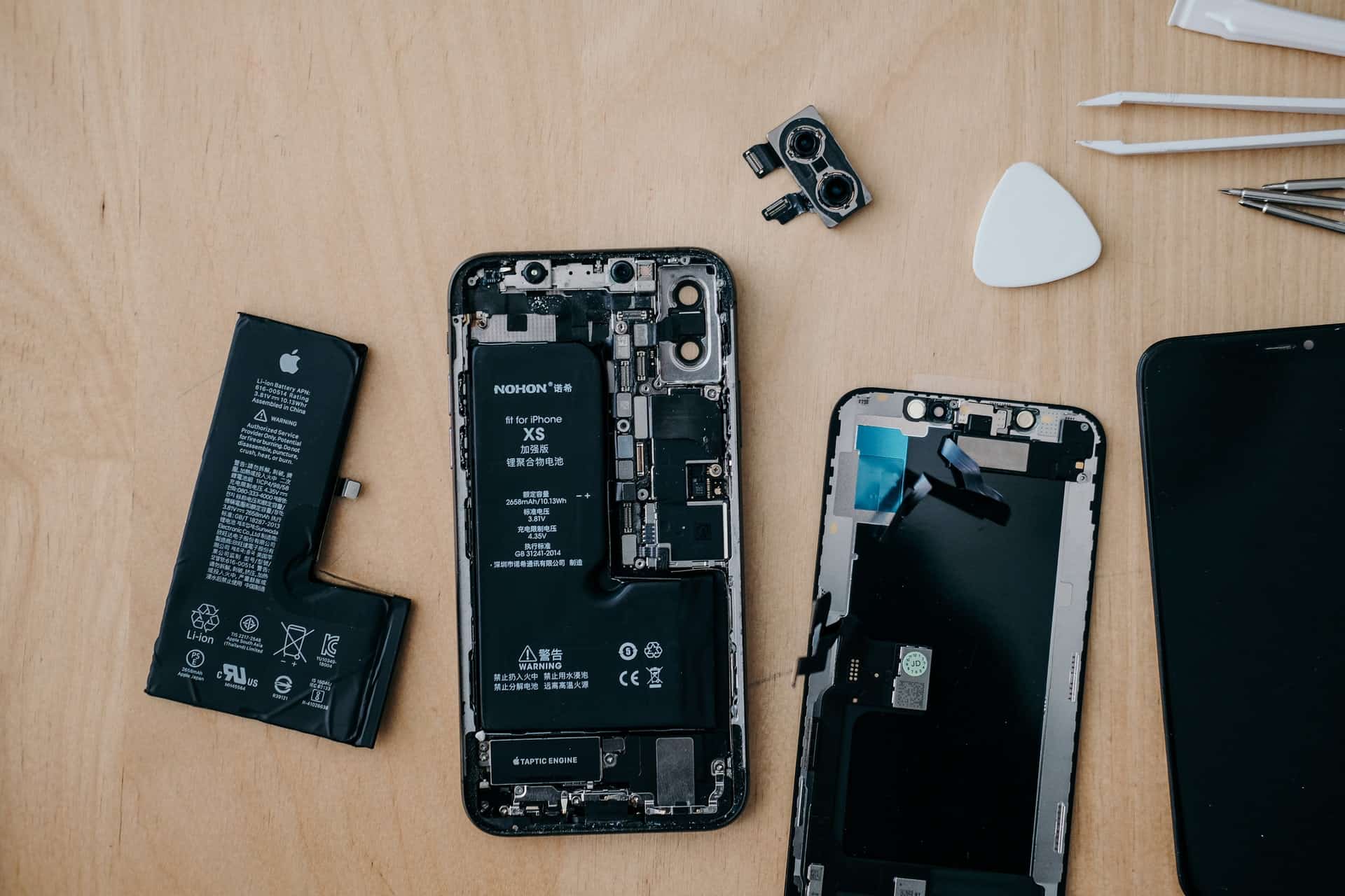 An iPhone that's been taken apart, showing the internal components